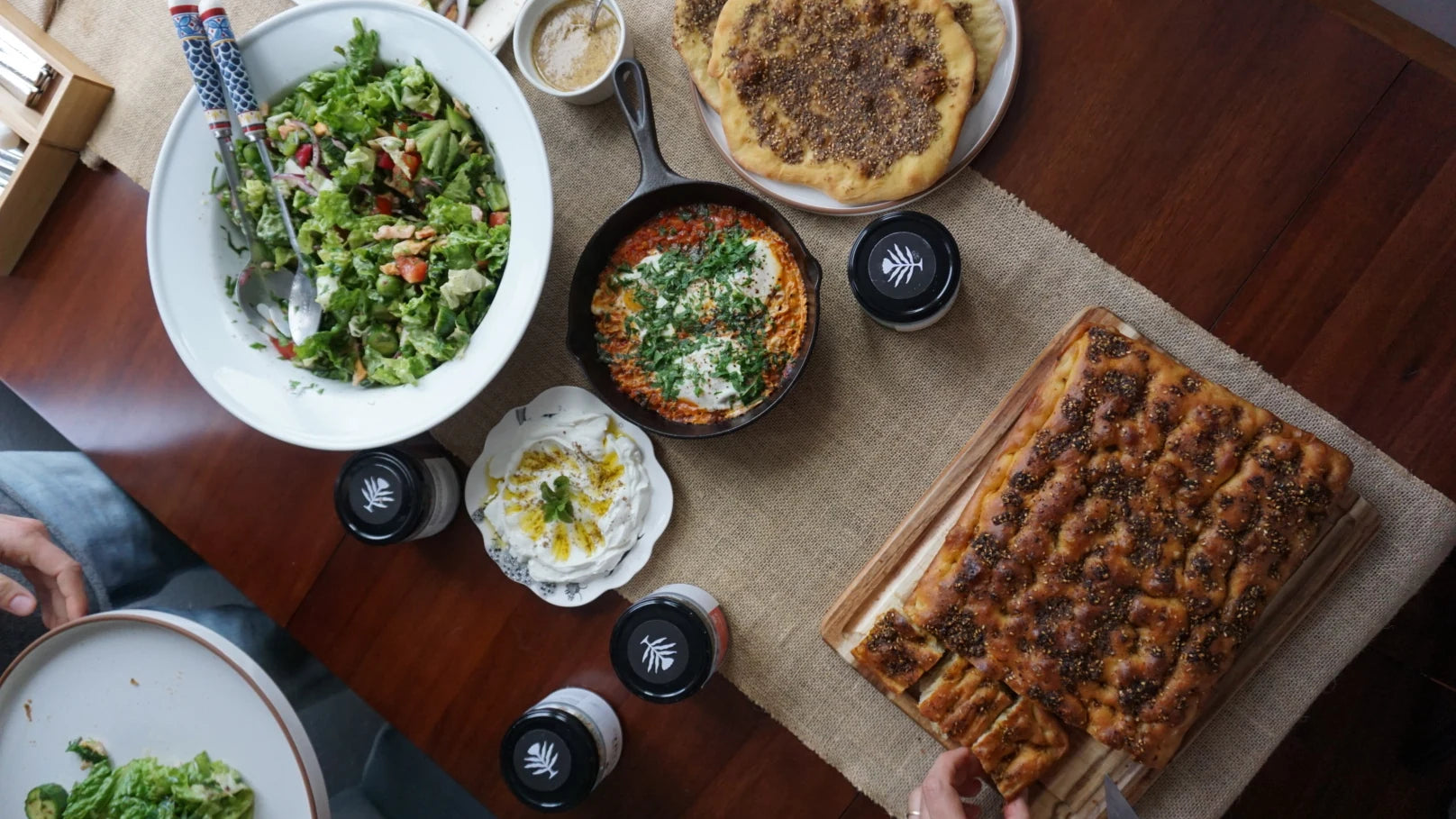 Lebanese dishes and Beirut Spice Co spice jars arranged on a table