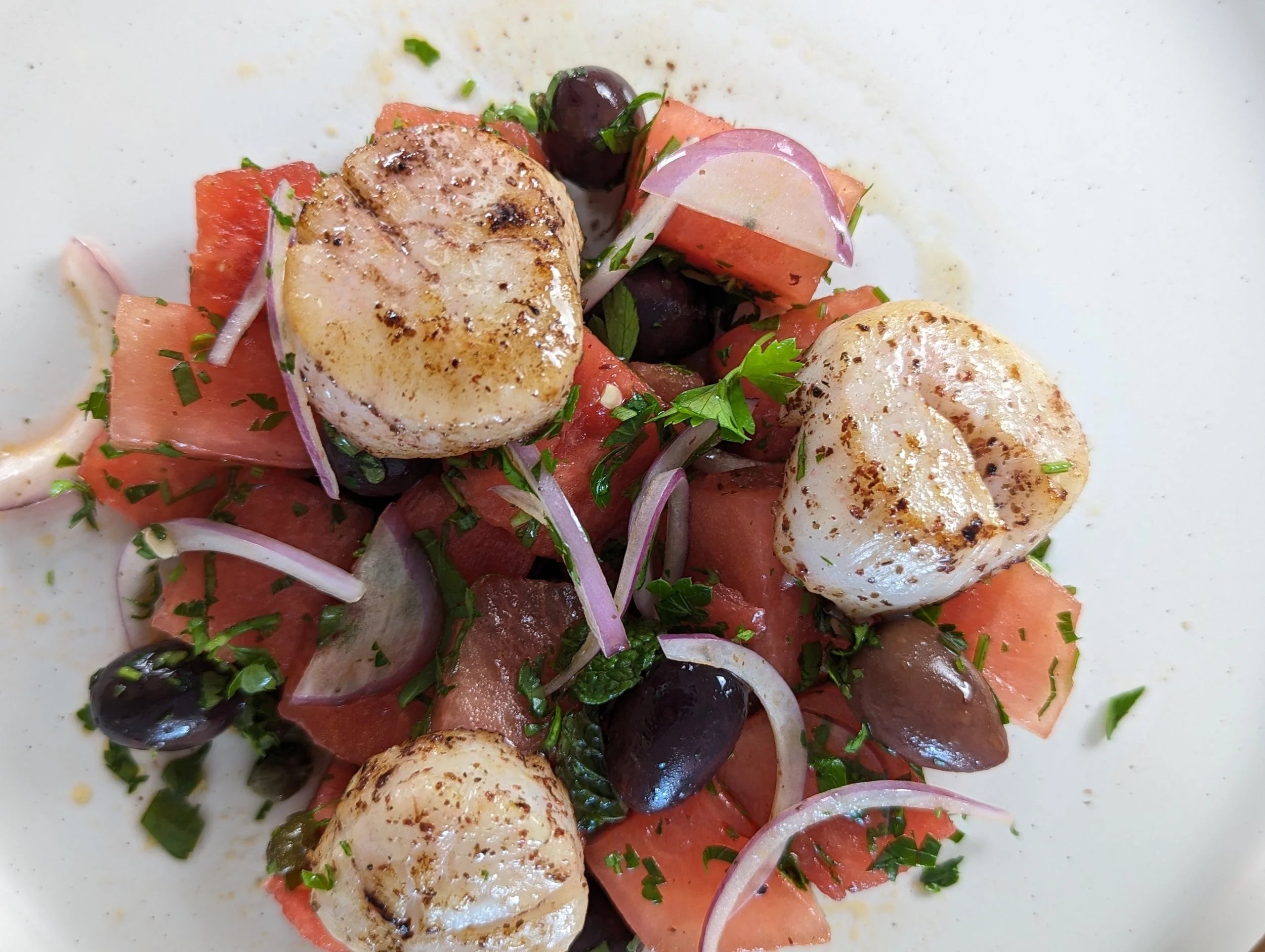 Seared scallops with watermelon, herbs, and sumac