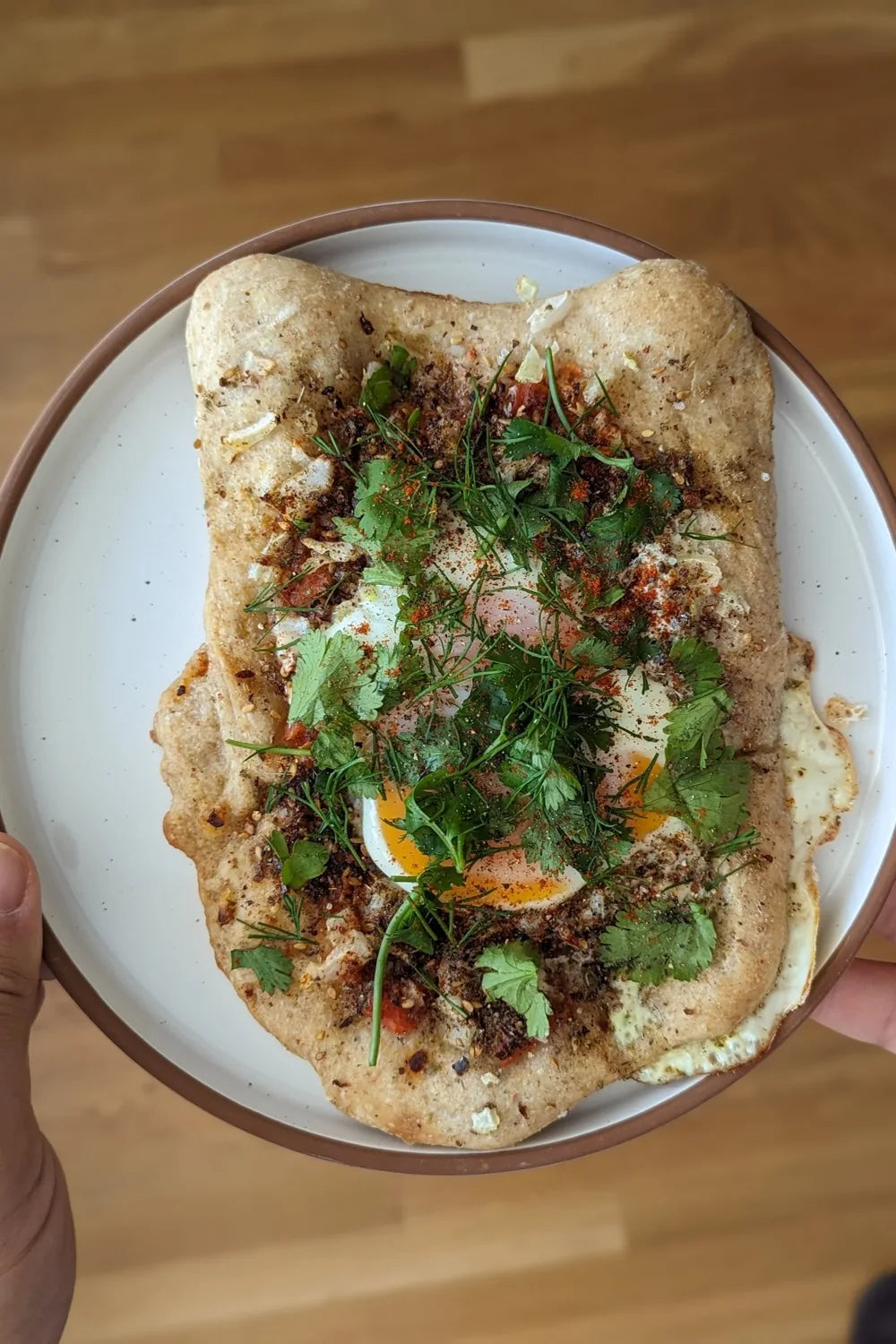 Za’atar flatbread topped with eggs and fresh herbs
